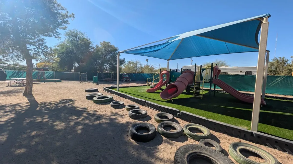 Shaded playground with slides and a tire course at D&J Cozy Casa
